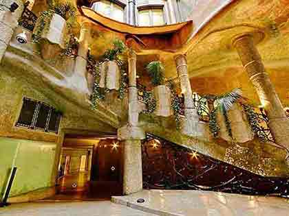 Interior of Casa Mila by Antoni Gaudi in Barcelona, showcasing unique architectural design.
